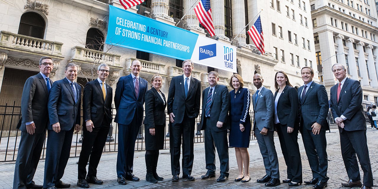  SilverPeak Strategic Capital leadership standing in front of the New York Stock Exchange with a banner celebrating SilverPeak Strategic Capital 's 100th anniversary in the background.